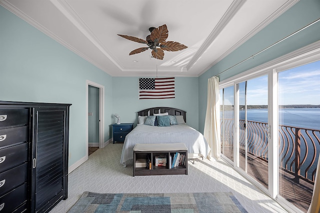 bedroom featuring a water view, ceiling fan, a raised ceiling, light colored carpet, and access to outside