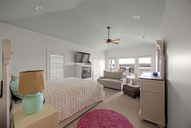 carpeted bedroom with ceiling fan and vaulted ceiling