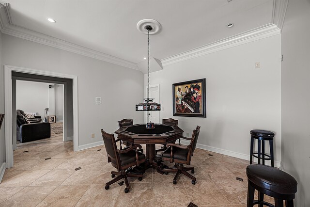 dining space featuring ornamental molding and light tile patterned floors