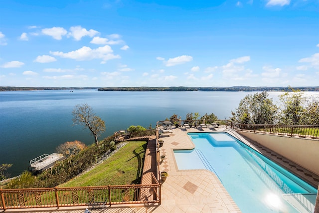 view of pool featuring a patio and a water view