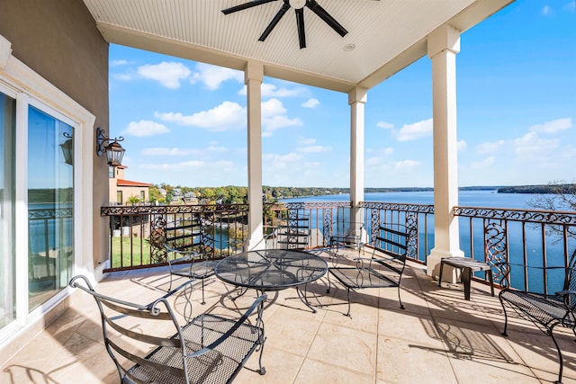 view of patio / terrace with ceiling fan, a balcony, and a water view