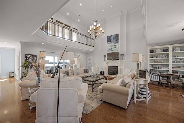 living room with dark hardwood / wood-style flooring, a notable chandelier, and ornamental molding