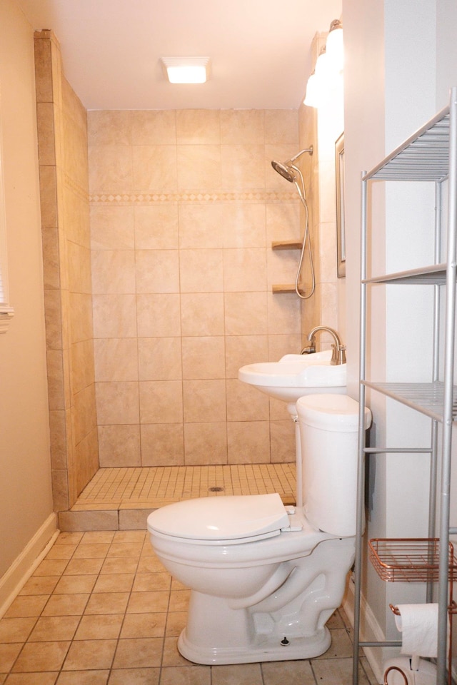 bathroom with tile patterned flooring, tiled shower, and toilet