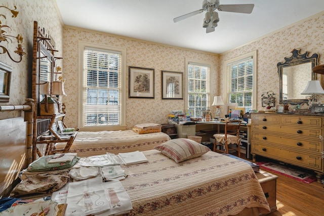 bedroom featuring hardwood / wood-style flooring and ceiling fan