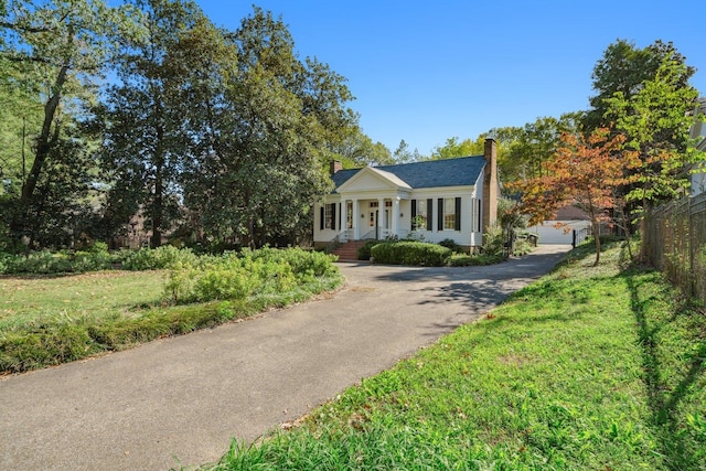 view of front facade with covered porch and a front yard