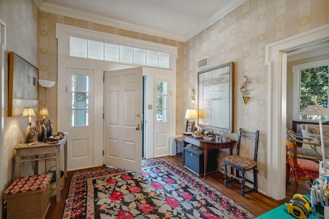 foyer featuring a wealth of natural light, crown molding, and dark hardwood / wood-style flooring