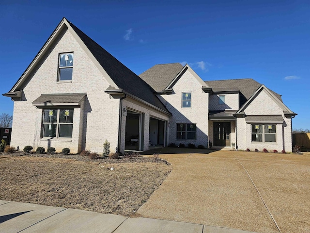 12064 Stromness Cv, Arlington, TN 38002 - view of front of home featuring brick siding, a garage, a shingled roof, and driveway