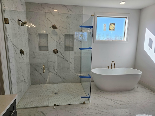 12064 Stromness Cv, Arlington, TN 38002 - bathroom with marble look tiles, a marble finish shower, a freestanding bath, vanity, and baseboards