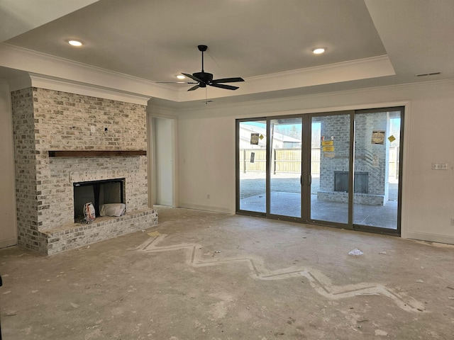 12064 Stromness Cv, Arlington, TN 38002 - unfurnished living room featuring crown molding, a tray ceiling, a ceiling fan, a brick fireplace, and recessed lighting