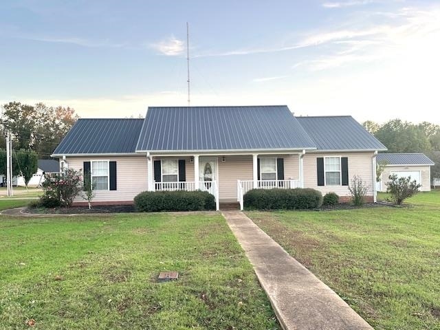 ranch-style home featuring a porch and a front lawn