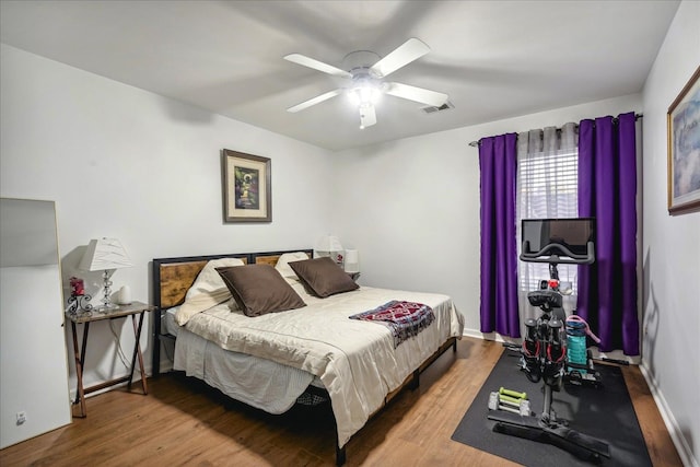 bedroom with wood-type flooring and ceiling fan