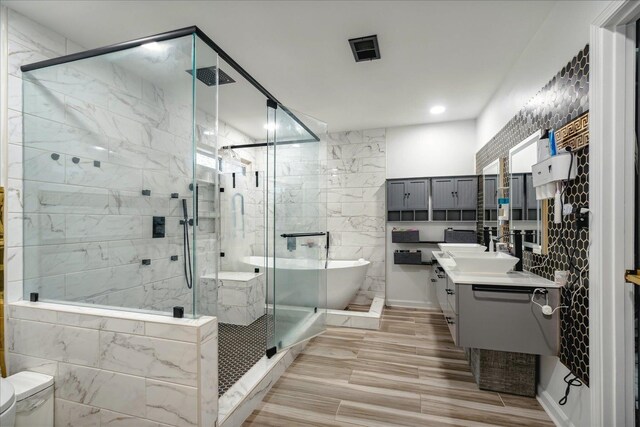 bathroom featuring independent shower and bath and vanity