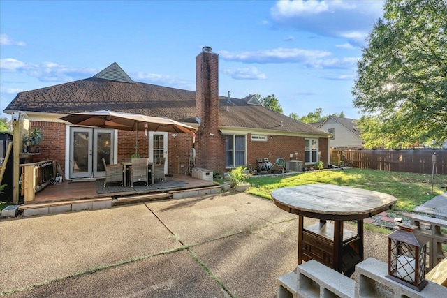 back of house with a patio area, a yard, and a deck