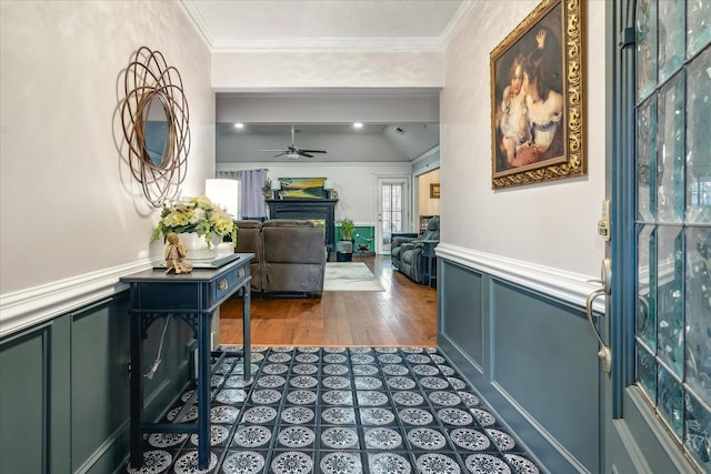 foyer featuring ceiling fan, dark hardwood / wood-style floors, and ornamental molding