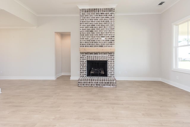 unfurnished living room featuring a brick fireplace, light hardwood / wood-style floors, and ornamental molding