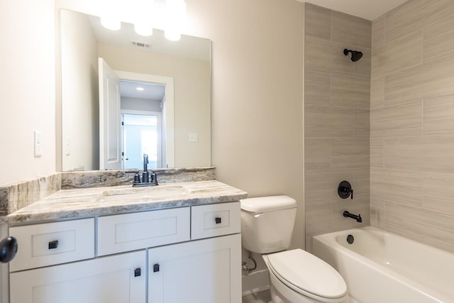 full bathroom with vanity, tiled shower / bath combo, and toilet