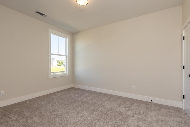 spare room featuring light colored carpet