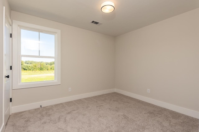 unfurnished room with plenty of natural light and light colored carpet