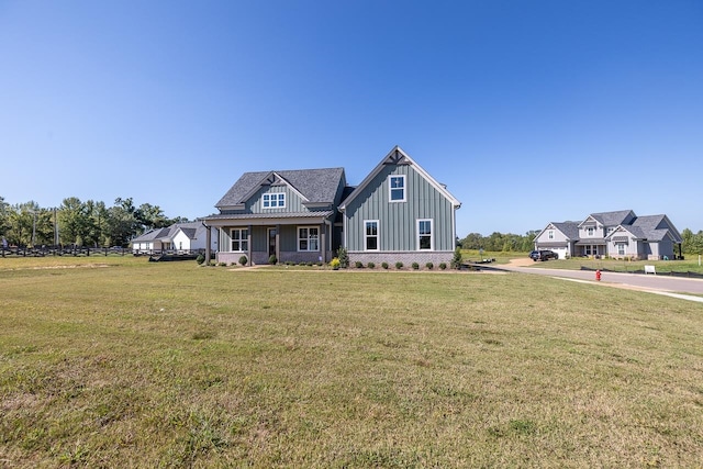 view of front of property with covered porch and a front lawn