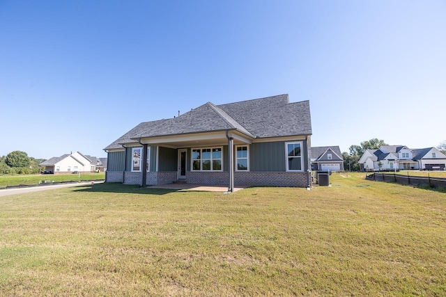 view of front of home featuring a front lawn and central AC unit