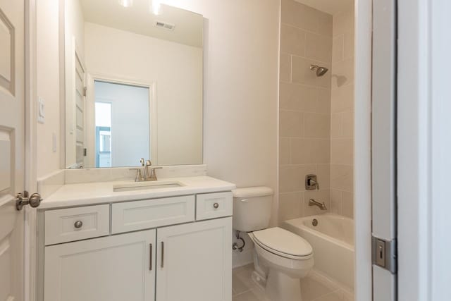 full bathroom with tile patterned flooring, vanity, toilet, and tiled shower / bath combo