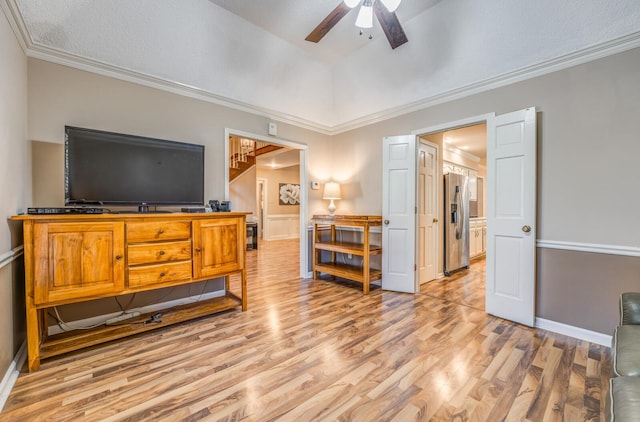 interior space featuring stainless steel fridge, ornamental molding, a textured ceiling, ceiling fan, and light hardwood / wood-style floors