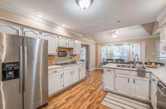 kitchen featuring white cabinets, appliances with stainless steel finishes, and light hardwood / wood-style flooring