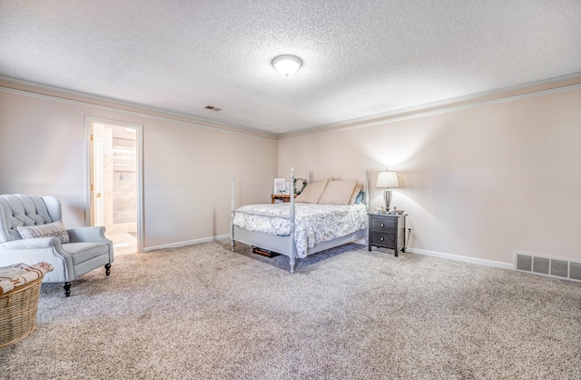 carpeted bedroom with a textured ceiling, ensuite bathroom, and ornamental molding