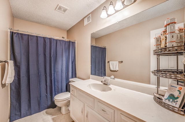 bathroom featuring tile patterned floors, curtained shower, vanity, toilet, and a textured ceiling