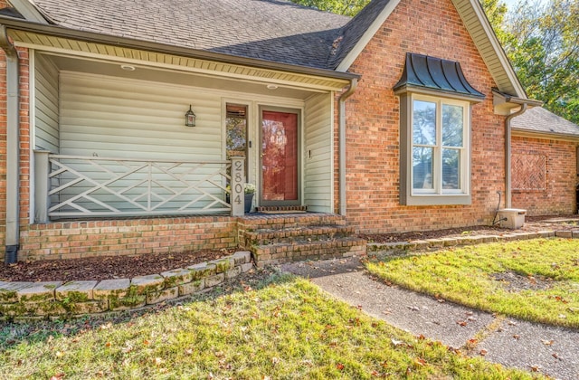 property entrance with a lawn