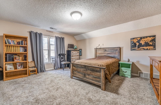 bedroom with carpet flooring, a textured ceiling, and lofted ceiling