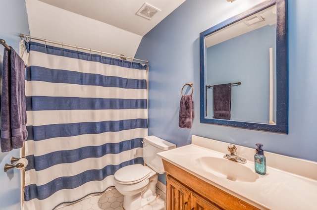 bathroom with tile patterned flooring, toilet, vanity, and walk in shower