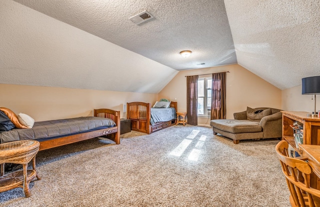 carpeted bedroom with lofted ceiling and a textured ceiling