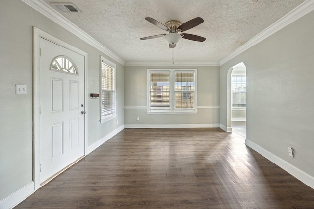 foyer entrance with a textured ceiling, ornamental molding, ceiling fan, and dark hardwood / wood-style flooring