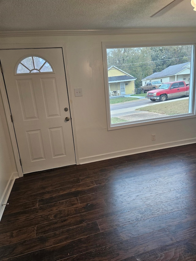 foyer entrance featuring a textured ceiling, dark hardwood / wood-style floors, and ceiling fan