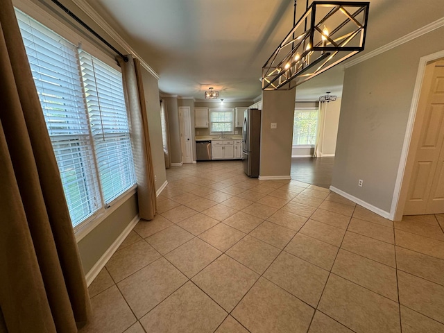 unfurnished dining area with ornamental molding, a notable chandelier, and light tile patterned floors