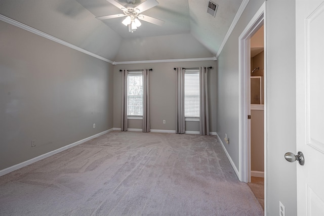 carpeted empty room with vaulted ceiling, ceiling fan, and ornamental molding