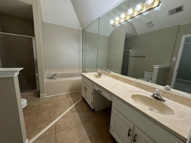 full bathroom with tile patterned floors, a textured ceiling, toilet, vanity, and independent shower and bath