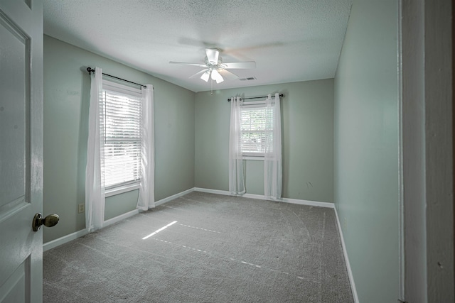 carpeted empty room featuring a textured ceiling and ceiling fan