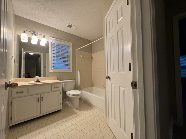 full bathroom featuring tile patterned floors, a textured ceiling, vanity, toilet, and tiled shower / bath