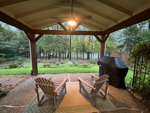 view of patio / terrace featuring area for grilling, ceiling fan, and a water view