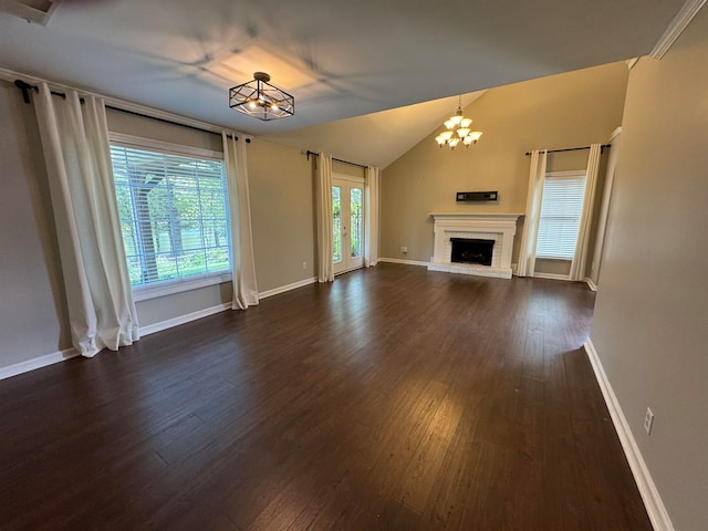 unfurnished living room featuring a fireplace, dark wood-type flooring, and an inviting chandelier