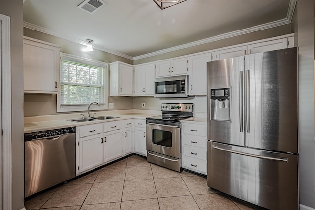 kitchen with ornamental molding, white cabinetry, sink, and appliances with stainless steel finishes