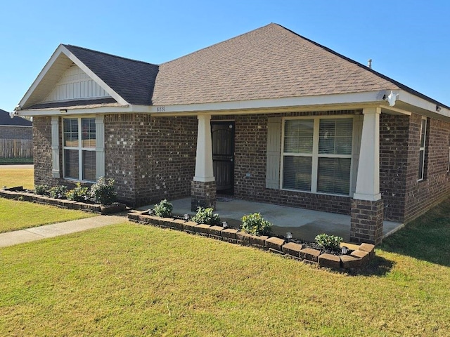 view of front of property with a front yard and covered porch