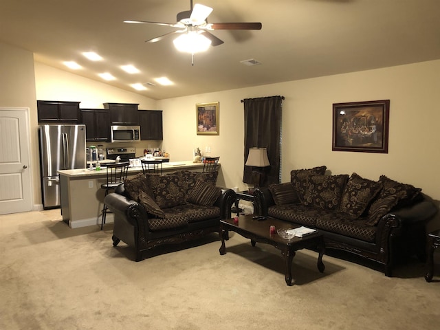 living room featuring lofted ceiling, light colored carpet, and ceiling fan