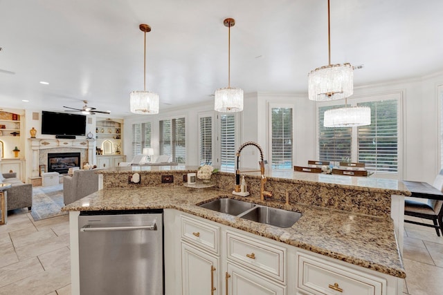 kitchen featuring dishwasher, hanging light fixtures, plenty of natural light, and sink