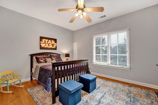 bedroom with hardwood / wood-style floors and ceiling fan