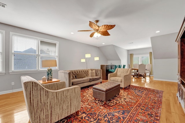 living room featuring ceiling fan, a healthy amount of sunlight, and light wood-type flooring