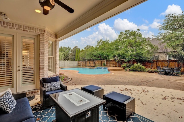 view of patio / terrace featuring a fenced in pool and ceiling fan