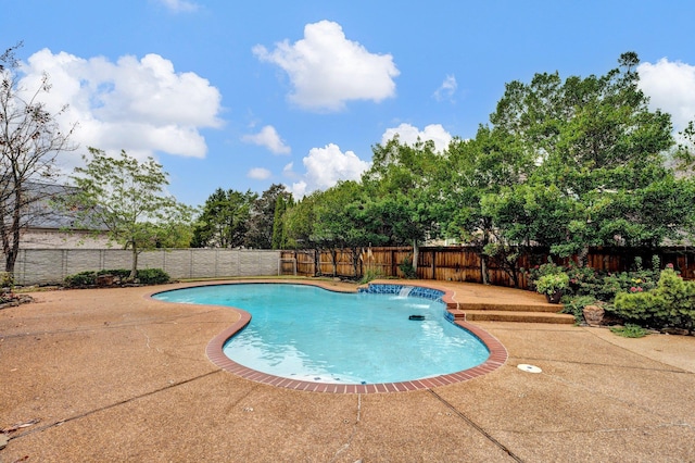 view of swimming pool featuring pool water feature and a patio